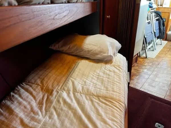 Slide: The Image of Interior of 1982 Uniflite Sport Fisher with cozy bed and wooden furnishings. - 12