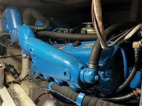 Slide: The Image of 1982 Uniflite Sport Fisher engine, blue, with visible hoses and components. - 17