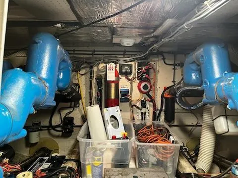 Slide: The Image of Engine room of a 1982 Uniflite Sport Fisher with blue machinery and organized tools. - 19