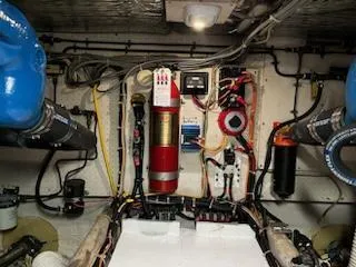 Slide: The Image of Engine room of a 1982 Uniflite Sport Fisher boat, featuring various mechanical components. - 21