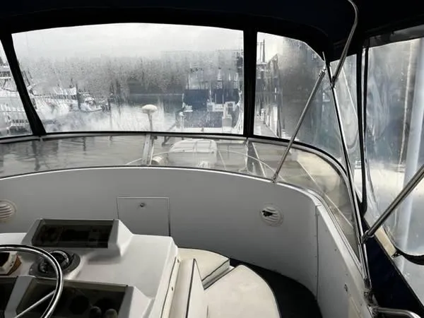 Slide: The Image of 1982 Uniflite Sport Fisher boat interior with foggy windows at a marina. - 3