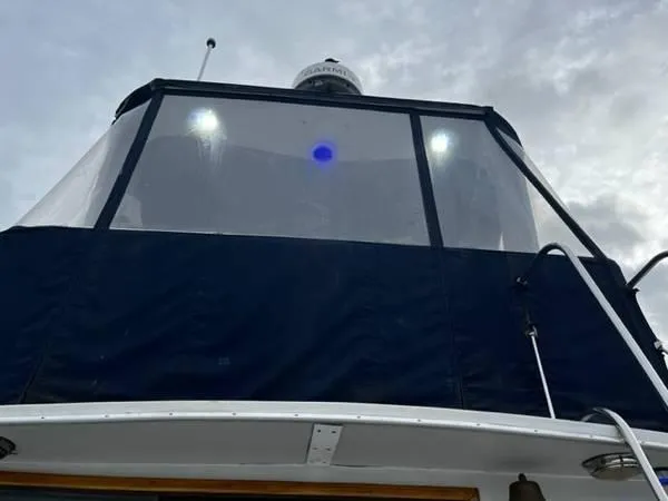 Slide: The Image of 1982 Uniflite Sport Fisher boat with enclosed upper deck and radar, viewed from below. - 4