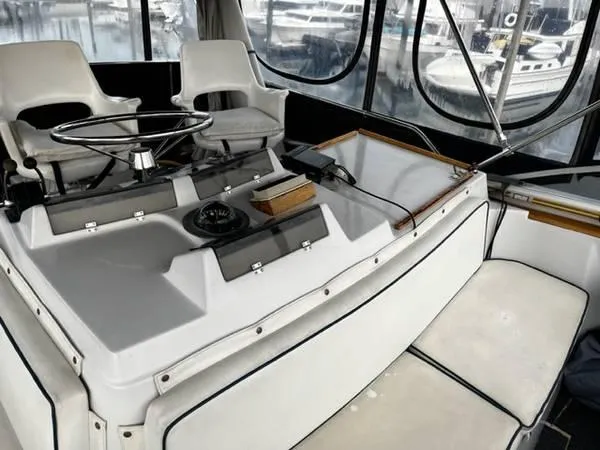 Slide: The Image of 1982 Uniflite Sport Fisher boat cockpit with steering wheel and seating. - 5