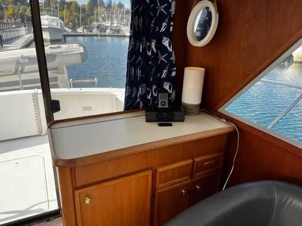 Slide: The Image of 1982 Uniflite Sport Fisher interior with wooden cabinetry and marina view. - 9