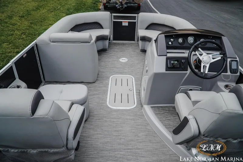 Slide: The Image of 2023 Bennington 23LSR pontoon boat interior with gray seating and steering console. - 6