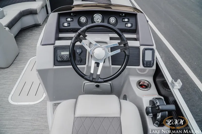 Slide: The Image of 2023 Bennington 23LSR boat dashboard with steering wheel and control panel at Lake Norman Marina. - 8