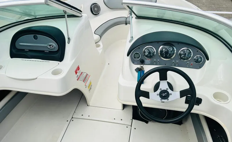 Slide: The Image of 2008 Sea Ray 205 Sport boat dashboard with steering wheel and instrument panel. - 10