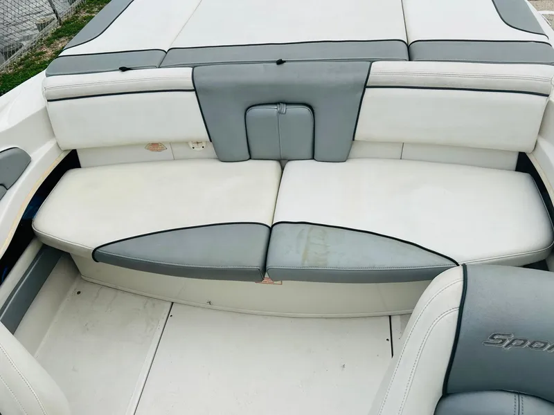 Slide: The Image of 2008 Sea Ray 205 Sport boat interior with gray and white seating. - 12