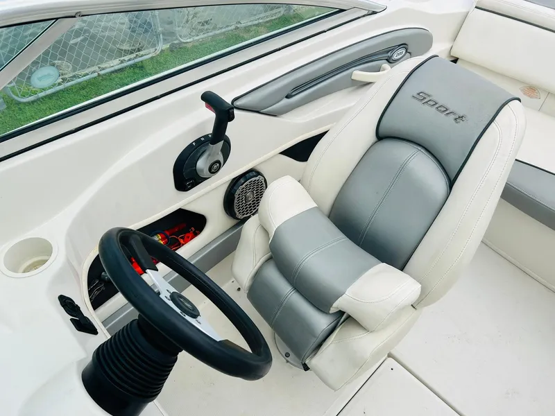Slide: The Image of 2008 Sea Ray 205 Sport boat interior with steering wheel and cushioned seat. - 15