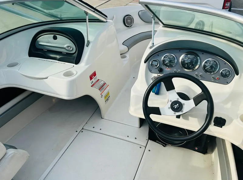 Slide: The Image of 2008 Sea Ray 205 Sport boat interior with steering wheel and dashboard controls. - 16