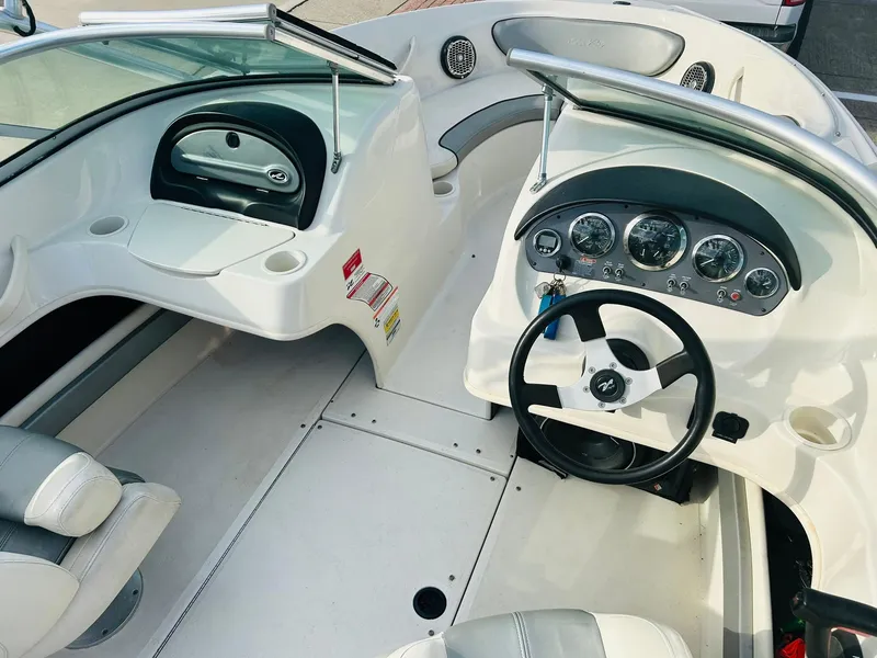 Slide: The Image of 2008 Sea Ray 205 Sport boat interior with steering wheel and dashboard controls. - 19