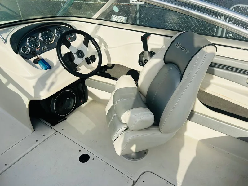 Slide: The Image of 2008 Sea Ray 205 Sport boat interior with steering wheel and captain's seat. - 21