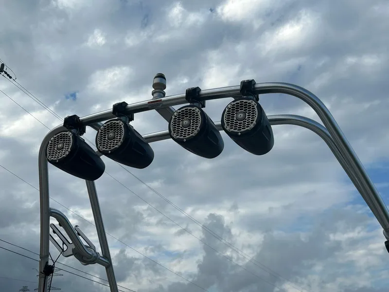 Slide: The Image of Four marine speakers mounted on a Sea Ray 205 Sport boat against a cloudy sky. - 23