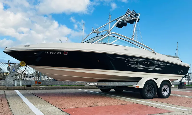 Slide: The Image of 2008 Sea Ray 205 Sport boat on trailer, dockside, under blue sky. - 6