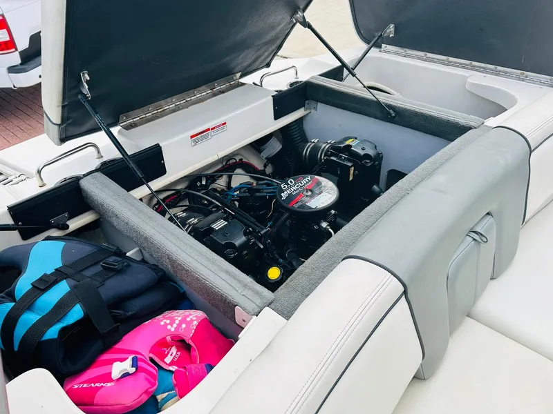 Slide: The Image of 2008 Sea Ray 205 Sport boat engine compartment with life jackets and storage. - 9