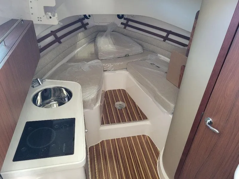 Slide: The Image of 2024 Grady-White Marlin 300 cabin interior with kitchenette and seating area. - 11