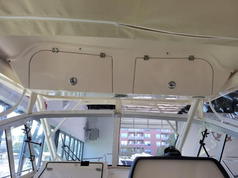 Slide: The Image of 2024 Grady-White Marlin 300 interior storage compartments and helm station. - 12