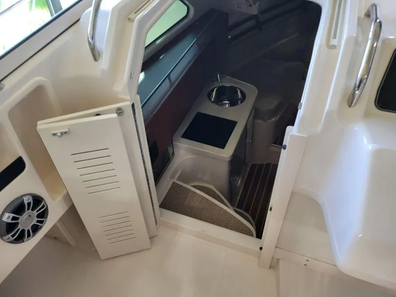 Slide: The Image of 2024 Grady-White Marlin 300 cabin interior with seating and storage. - 13