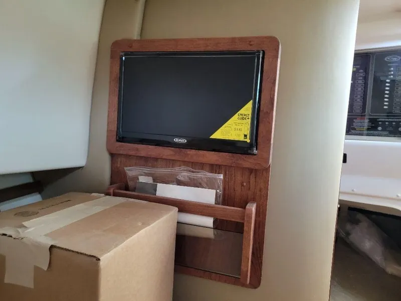 Slide: The Image of 2024 Grady-White Marlin 300 interior with mounted TV and storage shelf. - 16