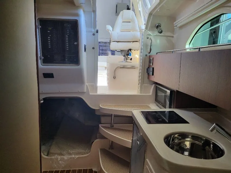 Slide: The Image of Interior of 2024 Grady-White Marlin 300 boat with kitchen and seating area. - 17