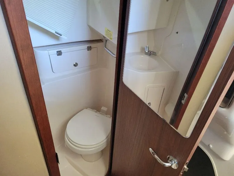 Slide: The Image of 2024 Grady-White Marlin 300 boat bathroom with toilet and sink. - 18