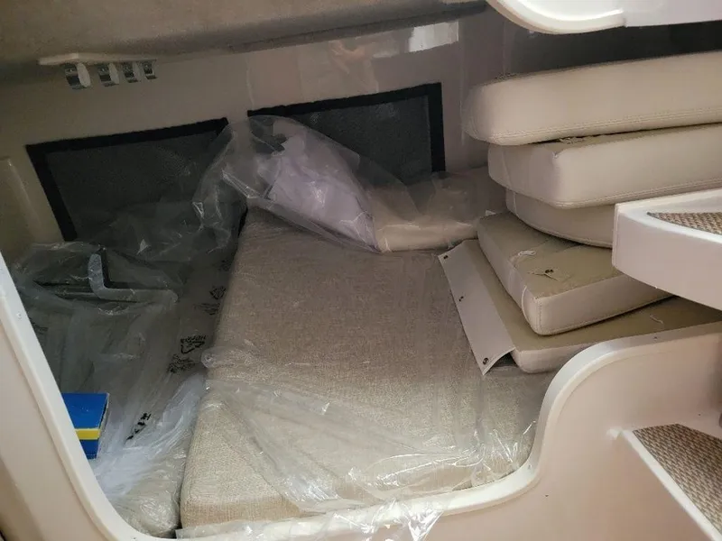 Slide: The Image of 2024 Grady-White Marlin 300 cabin interior with cushions and bedding. - 20