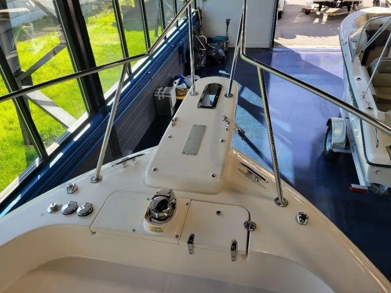 Slide: The Image of 2024 Grady-White Marlin 300 boat bow with anchor and railing in showroom. - 22