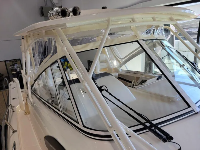 Slide: The Image of 2024 Grady-White Marlin 300 boat with hardtop and windshield in showroom. - 23