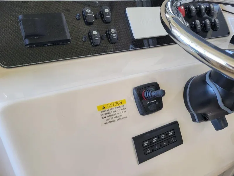 Slide: The Image of 2024 Grady-White Marlin 300 boat dashboard with steering wheel and control panel. - 26