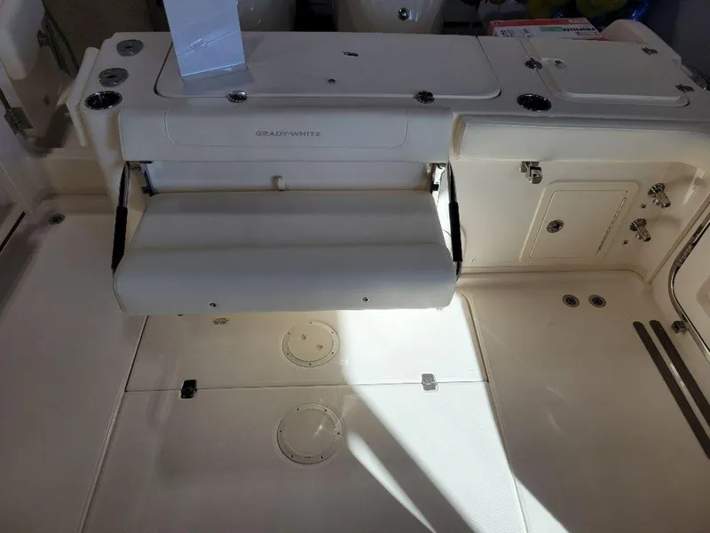 Slide: The Image of 2024 Grady-White Marlin 300 boat interior with foldable seat and storage compartments. - 5