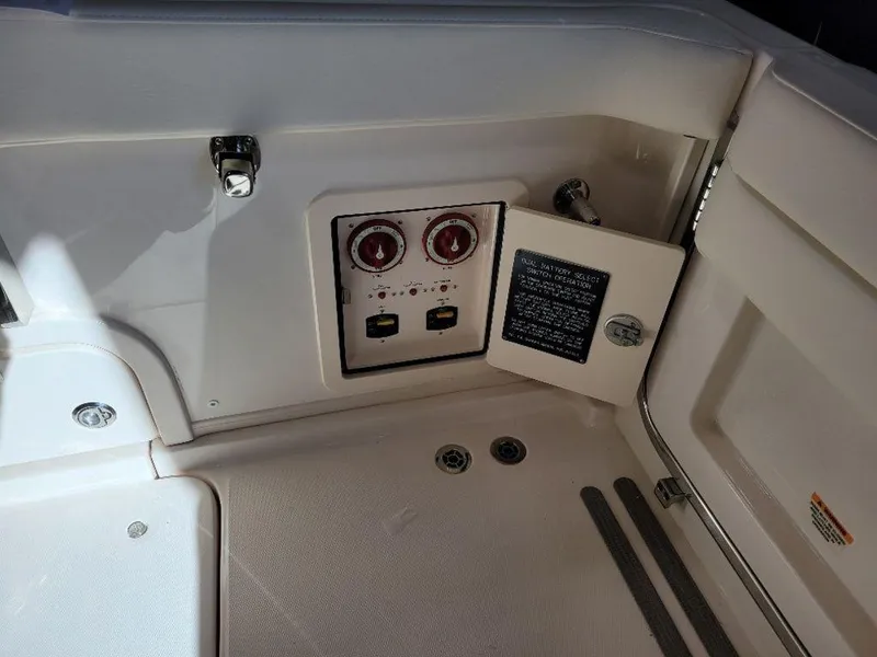 Slide: The Image of 2024 Grady-White Marlin 300 boat control panel with open access door. - 6