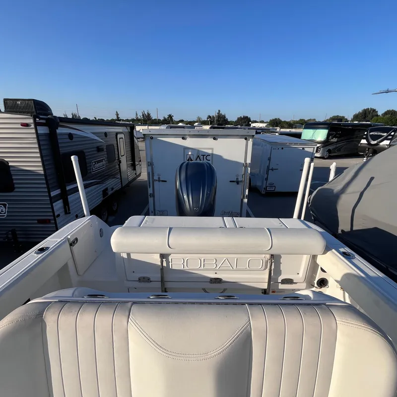 Slide: The Image of 2013 Robalo R240 Center Console boat in storage lot with trailers. - 10
