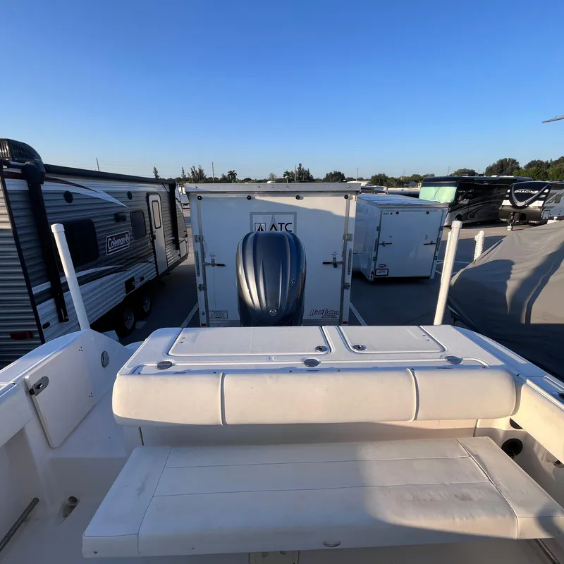 Slide: The Image of 2013 Robalo R240 Center Console boat with outboard motor in storage lot. - 13