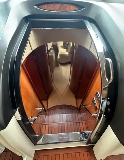 Slide: The Image of Interior view of 2002 Sunseeker 75 Predator yacht, showing wooden stairs and cabin entrance. - 11