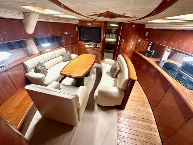 Slide: The Image of Luxurious interior of 2002 Sunseeker 75 Predator yacht with elegant seating and dining area. - 12
