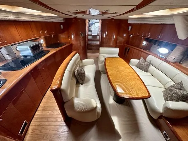 Slide: The Image of Luxurious interior of 2002 Sunseeker 75 Predator yacht with elegant seating and dining area. - 13