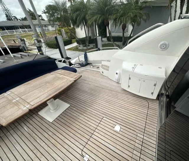 Slide: The Image of Sunseeker 75 Predator 2002 yacht deck with wooden flooring, seating, and table. - 3