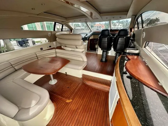 Slide: The Image of Luxurious interior of a 2002 Sunseeker 75 Predator yacht with leather seating and wooden flooring. - 6