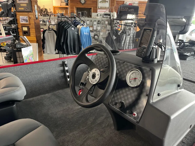 Slide: The Image of 2024 Tracker Bass Tracker Classic XL boat interior with steering wheel and dashboard. - 3