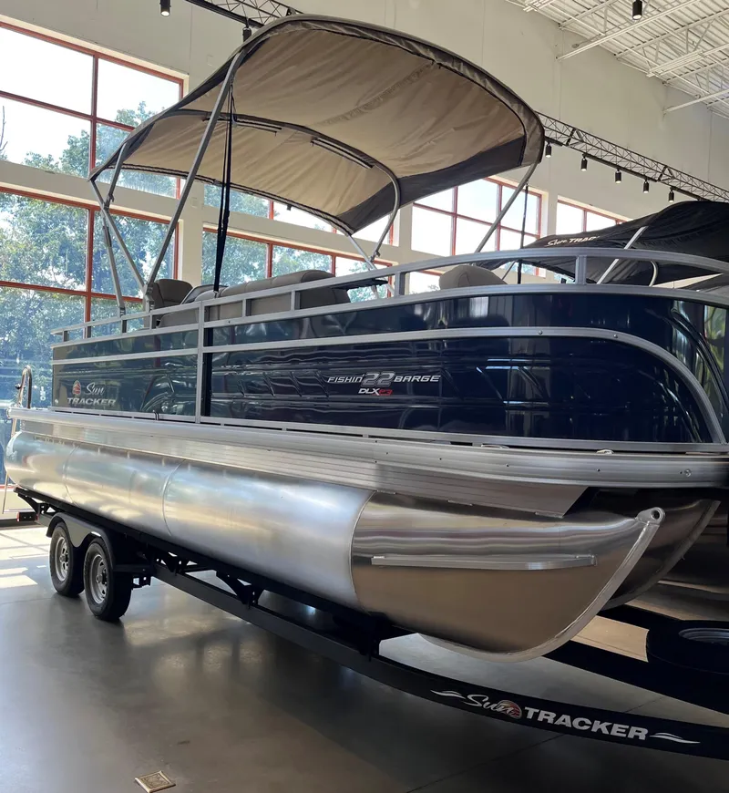 The Image of 2024 Sun Tracker Fishin' Barge 22 XP3 pontoon boat in showroom. - 0