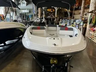 Slide: The Image of 2024 Tahoe T16 boat displayed in showroom with canopy and seating. - 4