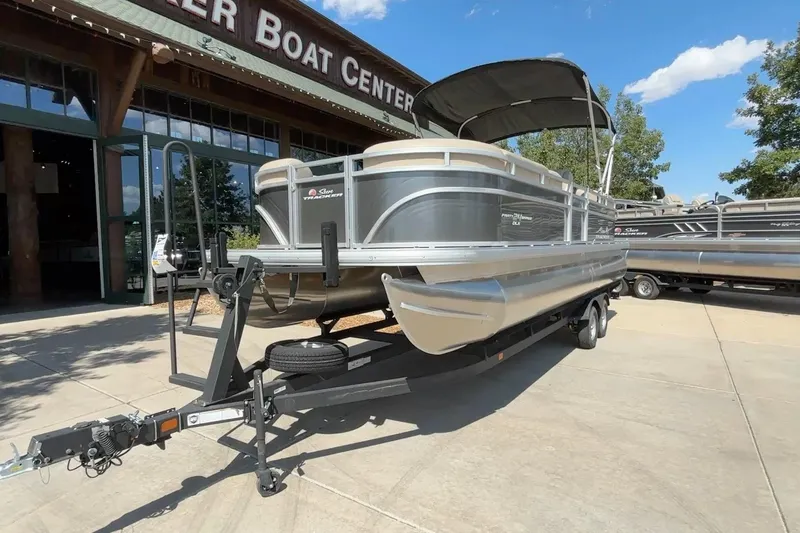 Slide: The Image of 2024 Sun Tracker Party Barge 24 DLX pontoon boat on trailer at dealership. - 13