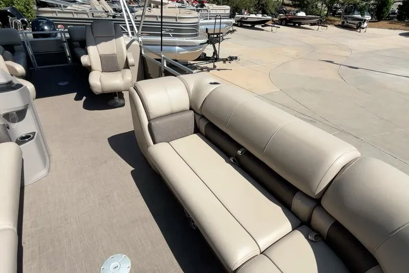 Slide: The Image of 2024 Sun Tracker Party Barge 24 DLX interior with plush seating and spacious layout. - 12