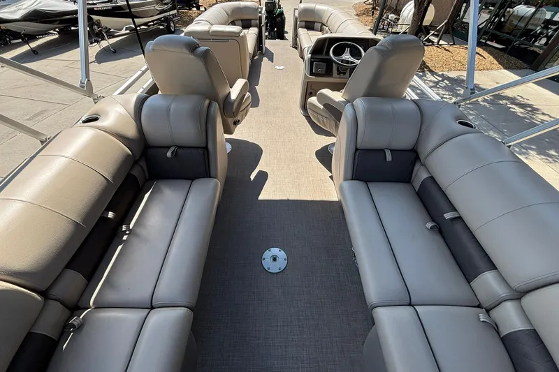 Slide: The Image of 2024 Sun Tracker Party Barge 24 DLX interior with spacious seating and modern helm. - 11