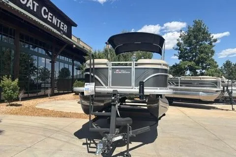Slide: The Image of 2024 Sun Tracker Party Barge 24 DLX pontoon boat displayed at a boat center. - 2