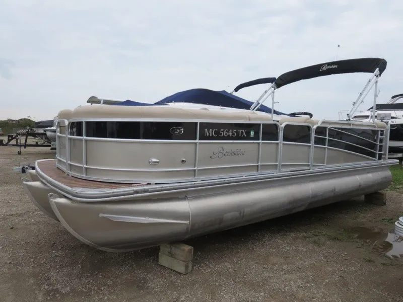 Slide: The Image of 2015 Berkshire 230CL STS pontoon boat on a gravel lot. - 0