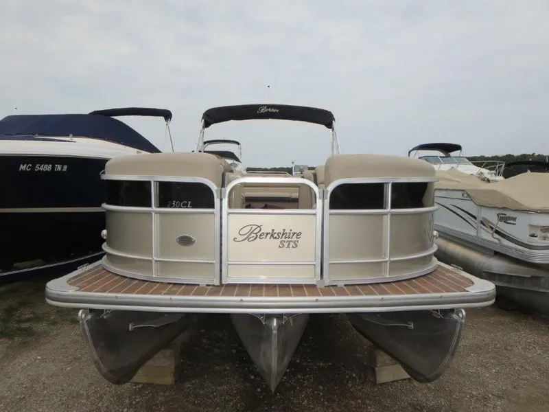 Slide: The Image of 2015 Berkshire 230CL STS pontoon boat docked, featuring sleek design and spacious deck. - 1