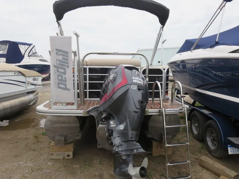 Slide: The Image of 2015 Berkshire 230CL STS pontoon boat with Evinrude 250 HP engine, docked outdoors. - 2