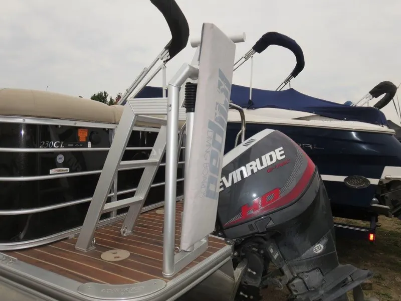 Slide: The Image of 2015 Berkshire 230CL STS pontoon boat with Evinrude outboard motor, docked. - 3