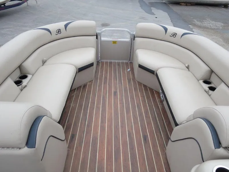 Slide: The Image of 2015 Berkshire 230CL STS pontoon boat with beige seating and wood-style flooring. - 6